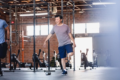 A man doing warm-ups in the gym before exercising.